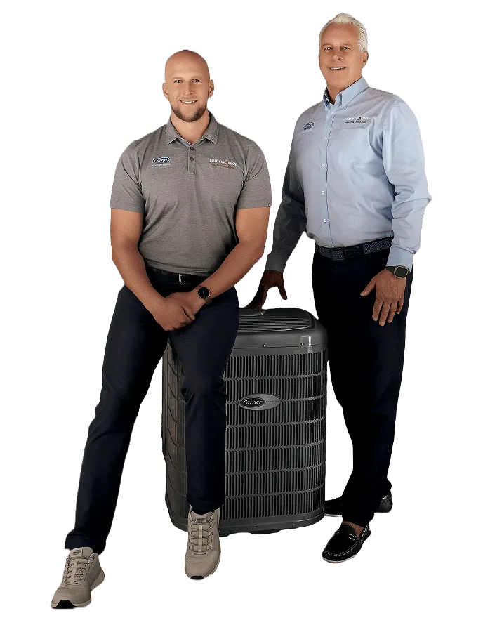 Two members of the Snazzy team beside an outdoor air conditioning unit